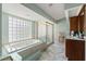 Bathroom suite with large soaker tub, separate shower, and ample natural light at 9276 Ashley Dr, Weeki Wachee, FL 34613
