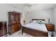 Comfortable bedroom has wood furniture, tile flooring and natural light at 9276 Ashley Dr, Weeki Wachee, FL 34613