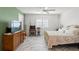 This bedroom features white tile flooring, a ceiling fan, and lots of natural light at 9276 Ashley Dr, Weeki Wachee, FL 34613