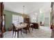 Formal dining room with chandelier lighting, vintage furniture, and tile flooring at 9276 Ashley Dr, Weeki Wachee, FL 34613