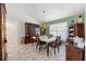 Formal dining room with chandelier lighting, vintage furniture, and tile flooring at 9276 Ashley Dr, Weeki Wachee, FL 34613