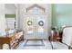 Bright foyer featuring tiled floors, double doors, and stylish décor on wooden furniture at 9276 Ashley Dr, Weeki Wachee, FL 34613