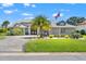 Charming single-story home with manicured lawn, mature landscaping, and a circular driveway at 9276 Ashley Dr, Weeki Wachee, FL 34613