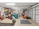 A spacious garage with ample storage space and two garage doors with a clean epoxy floor at 9276 Ashley Dr, Weeki Wachee, FL 34613
