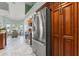 Bright kitchen with stainless steel refrigerator and matching oven, tile floors, custom cabinets, and breakfast nook at 9276 Ashley Dr, Weeki Wachee, FL 34613