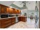 Traditional kitchen with stainless steel appliances, custom cabinets and marble tiled floors in a neutral color palette at 9276 Ashley Dr, Weeki Wachee, FL 34613
