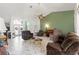 Spacious living room with high ceilings, tiled floor, and comfortable brown furniture at 9276 Ashley Dr, Weeki Wachee, FL 34613