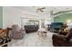 Bright and airy living room featuring tile floors and sliding glass doors to the pool area at 9276 Ashley Dr, Weeki Wachee, FL 34613