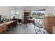 Bright office features a backyard view of the pool, and wood desks and shelving at 9276 Ashley Dr, Weeki Wachee, FL 34613
