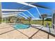 The screened in pool area features a spa and outdoor seating and well maintained greenery at 9276 Ashley Dr, Weeki Wachee, FL 34613