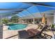 Relaxing screened in pool area with lounge chairs and patio furniture for outdoor living at 9276 Ashley Dr, Weeki Wachee, FL 34613