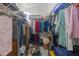 Spacious walk-in closet with hanging clothes and storage boxes provides ample storage at 9276 Ashley Dr, Weeki Wachee, FL 34613