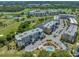 Overhead view of the condos overlooking a pond with fountain, golf course, and community pool at 960 Starkey Rd # 9104, Largo, FL 33771