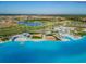 An aerial view of the community, showing the lagoon, amenities, and surrounding homes at 9828 Branching Ship Trace, Wesley Chapel, FL 33545