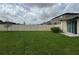 Spacious backyard with manicured lawn and privacy fence, perfect for outdoor enjoyment at 9828 Branching Ship Trace, Wesley Chapel, FL 33545