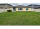 Well-maintained backyard with lush green grass, offering a private outdoor space at 9828 Branching Ship Trace, Wesley Chapel, FL 33545