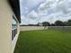 Expansive backyard with lush green grass and a well-maintained fence at 9828 Branching Ship Trace, Wesley Chapel, FL 33545