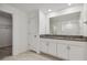 Bathroom with granite counters, double sinks, and tile floors at 9828 Branching Ship Trace, Wesley Chapel, FL 33545