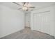 Bedroom with ceiling fan, carpet flooring, and closet at 9828 Branching Ship Trace, Wesley Chapel, FL 33545