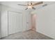 Bedroom with ceiling fan, carpet flooring, and closet at 9828 Branching Ship Trace, Wesley Chapel, FL 33545