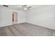 Spacious carpeted bedroom with ceiling fan and ensuite entry at 9828 Branching Ship Trace, Wesley Chapel, FL 33545