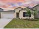 Charming single-story home with a well-maintained lawn and a two-car garage at 9828 Branching Ship Trace, Wesley Chapel, FL 33545