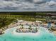 Beautiful lagoon with turquoise water, sandy beach, cabanas and palm trees for a resort style experience at 9828 Branching Ship Trace, Wesley Chapel, FL 33545