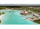 Stunning aerial view of lagoon with clear water, waterfront restaurants, and plenty of space for fun at 9828 Branching Ship Trace, Wesley Chapel, FL 33545