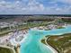 A stunning panoramic view of the expansive lagoon with community amenities and residences at 9828 Branching Ship Trace, Wesley Chapel, FL 33545