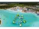 Overhead view of the lagoon's unique inflatable water park, inviting clear waters, and watersports at 9828 Branching Ship Trace, Wesley Chapel, FL 33545