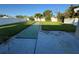 Extensive backyard with a green walkway and partial concrete patio at 6034 Bayou Grande Ne Blvd, St Petersburg, FL 33703