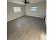 A bright bedroom with two windows, a ceiling fan, and beautiful wood-look flooring at 6034 Bayou Grande Ne Blvd, St Petersburg, FL 33703