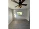 A bright bedroom with a ceiling fan, one window, and beautiful wood-look flooring at 6034 Bayou Grande Ne Blvd, St Petersburg, FL 33703