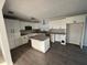 Spacious kitchen with white cabinetry, granite countertops, and a kitchen island at 6034 Bayou Grande Ne Blvd, St Petersburg, FL 33703