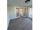Bright, open space with French doors and windows flooding the room with natural light and wood-look flooring at 6034 Bayou Grande Ne Blvd, St Petersburg, FL 33703