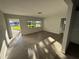 Bright living room featuring wood-look flooring and large windows at 6034 Bayou Grande Ne Blvd, St Petersburg, FL 33703