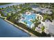 Aerial view of the community's amenities, including the pool, tennis courts, and clubhouse at 10486 Sea Breeze Ridge Dr, Englewood, FL 34223