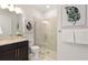 Modern bathroom featuring sleek vanity, glass enclosed shower, and decorative leaf art at 10486 Sea Breeze Ridge Dr, Englewood, FL 34223