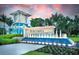 Entrance to the Beachwalk community with blue accents, water features, and lush landscaping at 10486 Sea Breeze Ridge Dr, Englewood, FL 34223