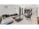 This bright living room has modern furniture, a dining area, and large windows for natural light at 10486 Sea Breeze Ridge Dr, Englewood, FL 34223