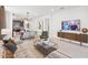 Open-concept living room showcases modern furnishings, dining area, and a TV for entertainment at 10486 Sea Breeze Ridge Dr, Englewood, FL 34223