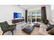 Bright living room features modern furnishings and a sliding glass door leading to the lanai at 10486 Sea Breeze Ridge Dr, Englewood, FL 34223