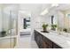 Bright main bathroom showcases double sinks, a glass enclosed shower, and access to bedroom at 10486 Sea Breeze Ridge Dr, Englewood, FL 34223