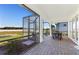 Spacious screened patio with brick pavers and outdoor seating area at 10486 Sea Breeze Ridge Dr, Englewood, FL 34223