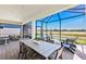 Comfortable screened patio area with dining and seating, perfect for entertaining guests at 10486 Sea Breeze Ridge Dr, Englewood, FL 34223