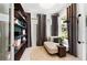 This sitting area features built in shelving, natural light from the windows, and neutral earth tones at 10486 Sea Breeze Ridge Dr, Englewood, FL 34223