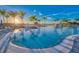 Large swimming pool with waterfall feature and plenty of lounge chairs for relaxing at 10486 Sea Breeze Ridge Dr, Englewood, FL 34223