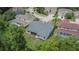 The rear exterior of the property showcasing its backyard, screened porch, and nearby landscaping at 10515 Canary Isle Dr, Tampa, FL 33647