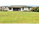 Exterior of home, featuring a screened in patio, a spacious yard, and mature landscaping at 10515 Canary Isle Dr, Tampa, FL 33647