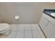 Small bathroom featuring a toilet, vanity with a sink, and neutral wall and floor tiles at 10515 Canary Isle Dr, Tampa, FL 33647